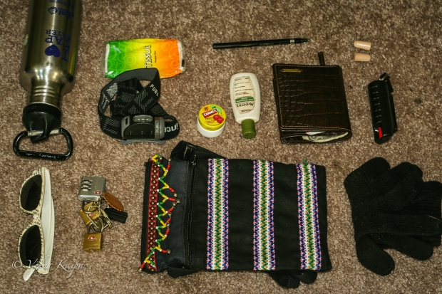Carmex (More Recommendations: water bottle, sunglasses, headlamp, tissues, hand lotion, eyeliner, earplugs, pepper spray, gloves (for winter travel), luggage locks, small pouch)